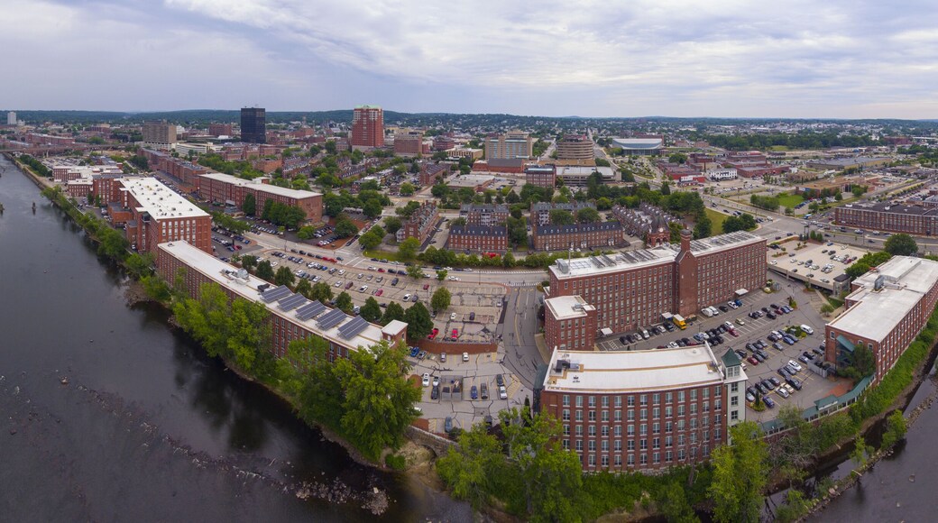 Manchester downtown building including City Hall Plaza and Brady Sullivan Plaza with Merrimack River in the front panorama aerial view, Manchester, New Hampshire, NH, USA.