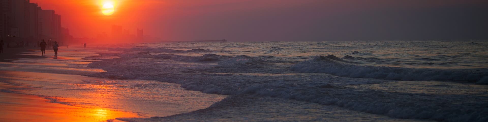 People on beach at sunset, North Myrtle Beach, South Carolina, United States