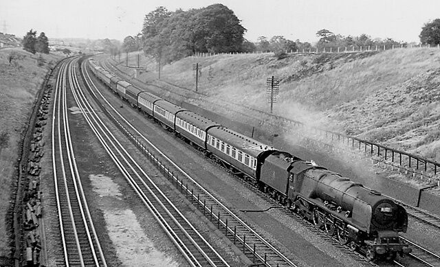 Panoramic view of West Coast Main Line near Hatch End with Up express. View NW, towards Watford Junction and the North; ex-London & North Western trunk line, Euston - Rugby - (Birmingham) - Crewe - Carlisle - (Glasgow). The express is on the Up Fast line, the Down and Up Slow lines being beyond; the nearest (4th-rail electrified) lines are the Euston/Broad St. - Watford Junction lines, which until 1982 also conveyed LT Underground (Bakerloo Line) trains beyond Harrow & Wealdstone. The express is the 06.35 Workington/09.55 Morecambe to Euston, headed by 'Coronation' 4-6-2 No. 46240 'City of Coventry'.