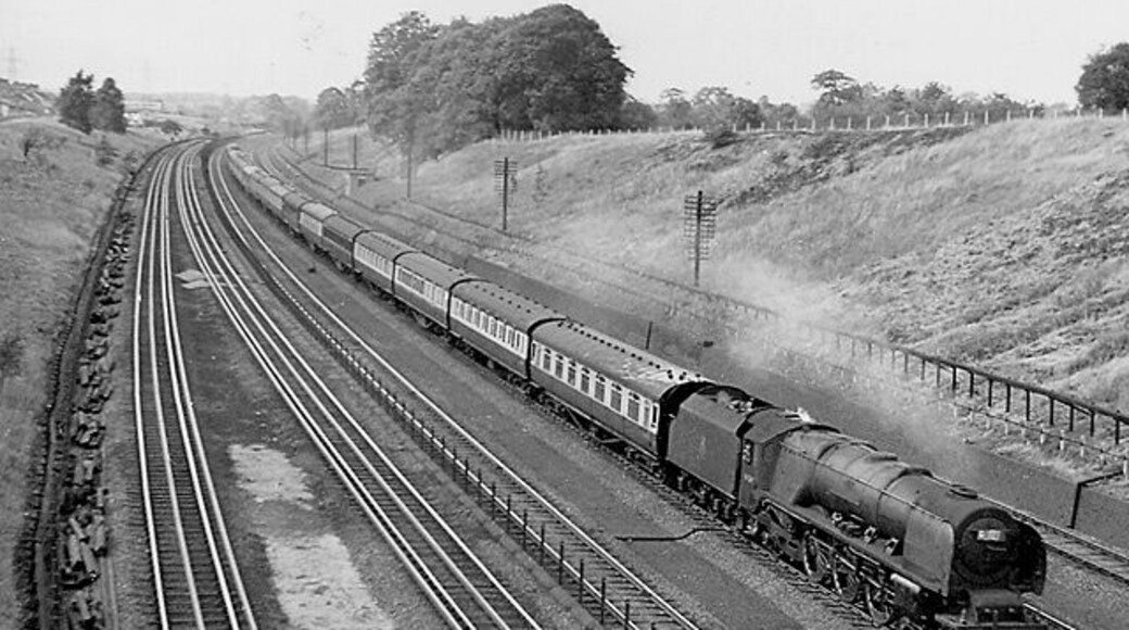 Panoramic view of West Coast Main Line near Hatch End with Up express. View NW, towards Watford Junction and the North; ex-London & North Western trunk line, Euston - Rugby - (Birmingham) - Crewe - Carlisle - (Glasgow). The express is on the Up Fast line, the Down and Up Slow lines being beyond; the nearest (4th-rail electrified) lines are the Euston/Broad St. - Watford Junction lines, which until 1982 also conveyed LT Underground (Bakerloo Line) trains beyond Harrow & Wealdstone. The express is the 06.35 Workington/09.55 Morecambe to Euston, headed by 'Coronation' 4-6-2 No. 46240 'City of Coventry'.