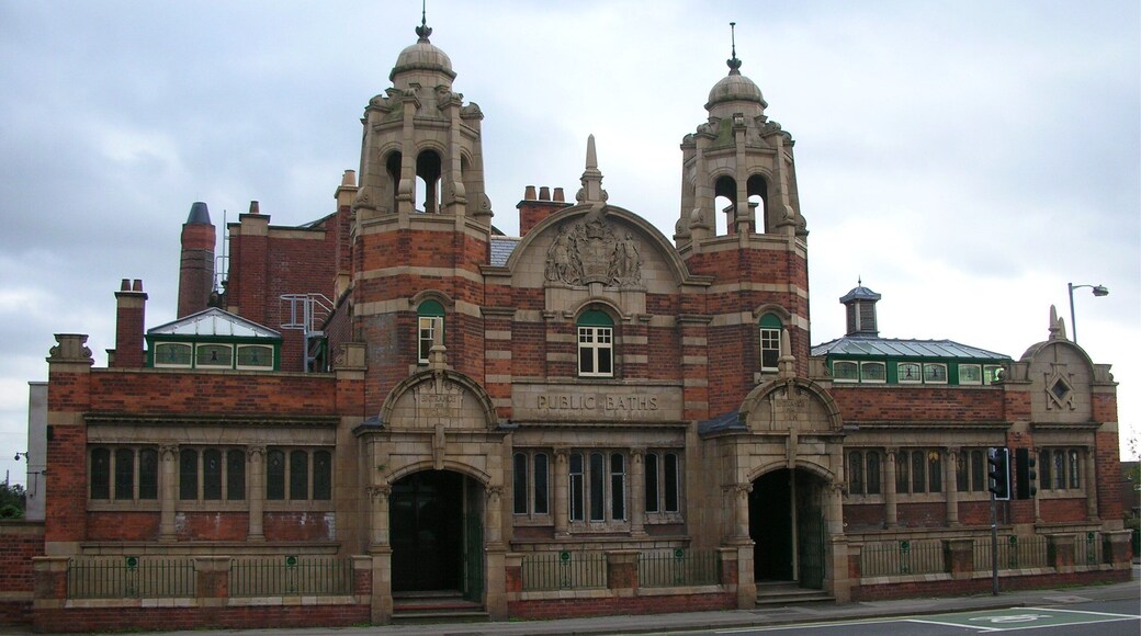 The public swimming baths at Nechells, Birmingham, England. A grade II listed building opened 1910, designed by Arthur Harrison. The sculpted coat of arms of Birmingham in the central arch is by Benjamin Creswick.