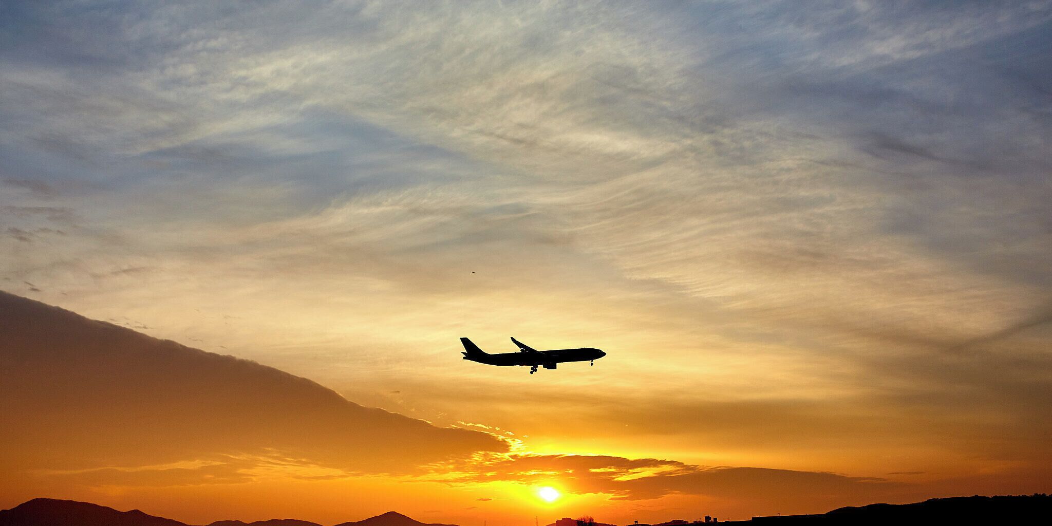 500px provided description: Incheon Airport, a plane comes in for landing during a colorful sunset. [#plane ,#sunset ,#contrast ,#clouds ,#colors ,#airplane ,#flying ,#aviation ,#backlight]