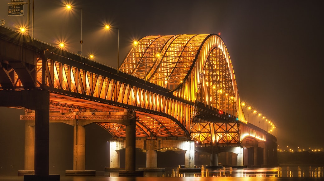 banghwa bridge at night over the han river in seoul, south korea