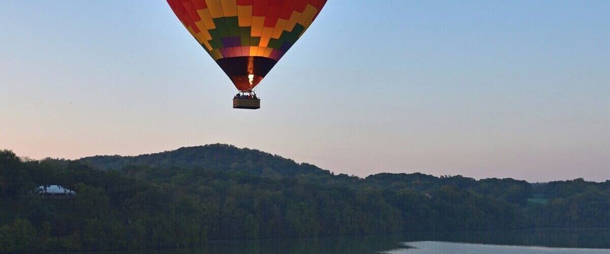 A vertical shot of a hot air balloon drifting over Lake Galena. This is a magnificent sight on a calm Fall morning. This is a must do activity for anyone who visits the area. The best time to go is in Fall when the colors are changing.