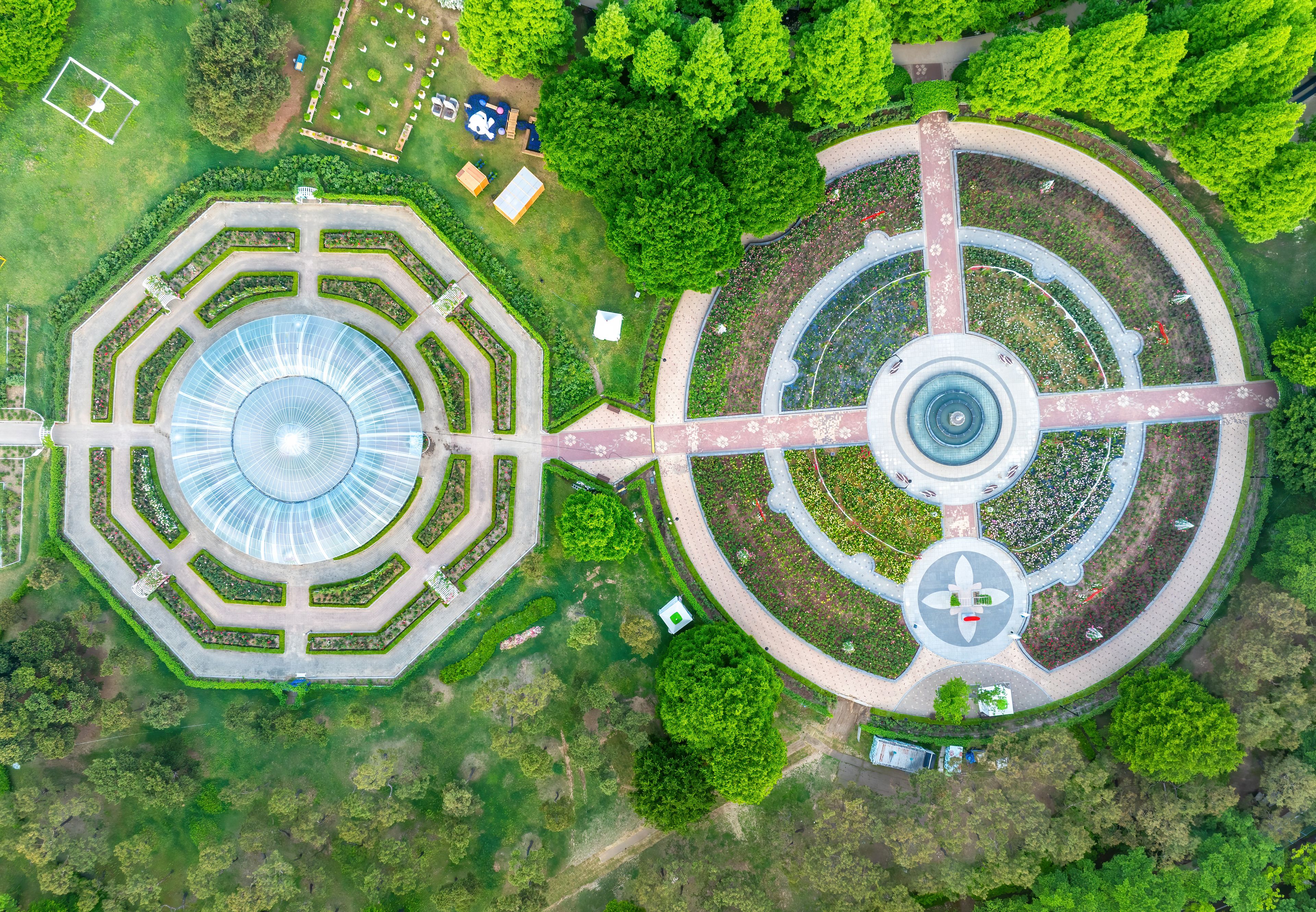 Janghang-dong, Ilsan, Goyang-si, Gyeonggi-do, South Korea - May 4, 2024: Aerial and top angle view of round walking trail with trees on the garden of Ilsan Lake Park