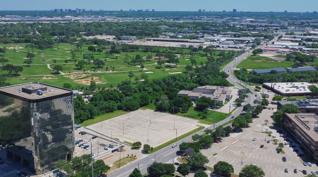 Panorama aerial view urbanized zones, business park in Northwest Dallas with downtown Irving, Denton in distant background, group of office buildings, hotels, restaurants with ample parking space