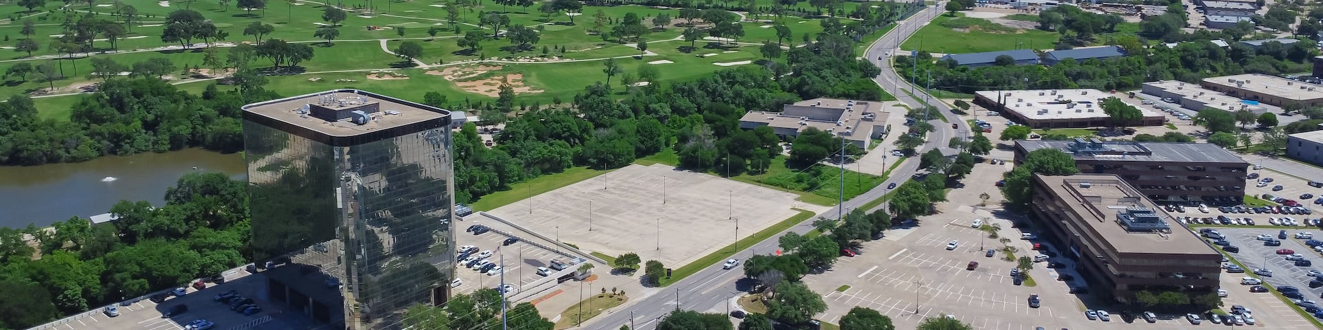 Panorama aerial view urbanized zones, business park in Northwest Dallas with downtown Irving, Denton in distant background, group of office buildings, hotels, restaurants with ample parking space