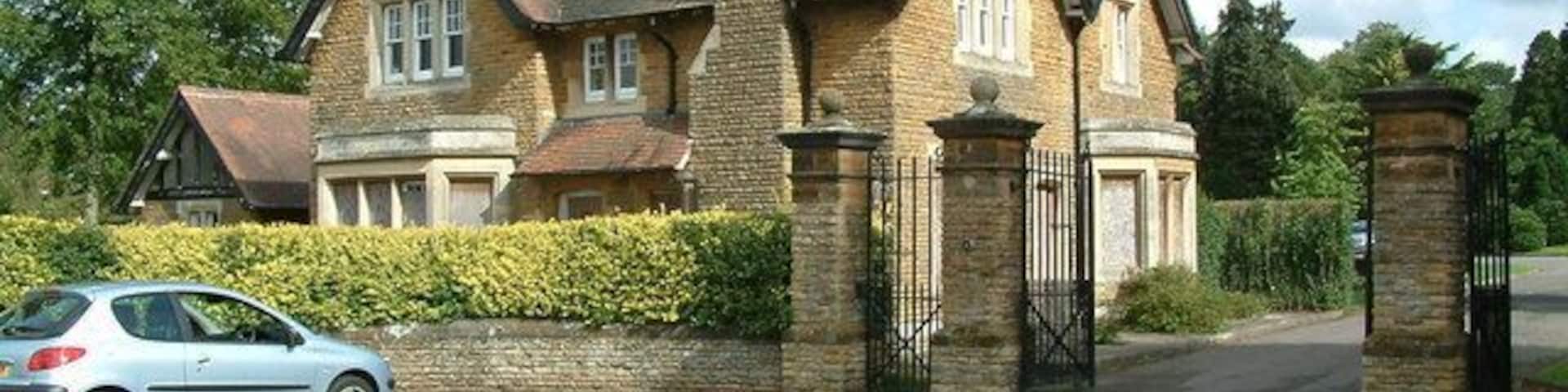 A large, two-story house with a brick exterior and a chimney.