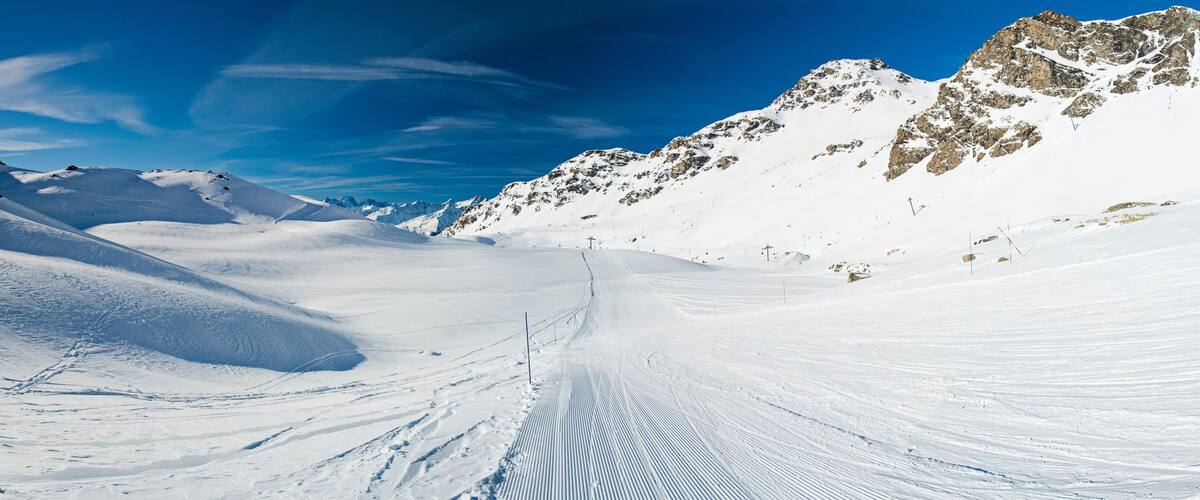 Skiers on a piste in alpine ski resort