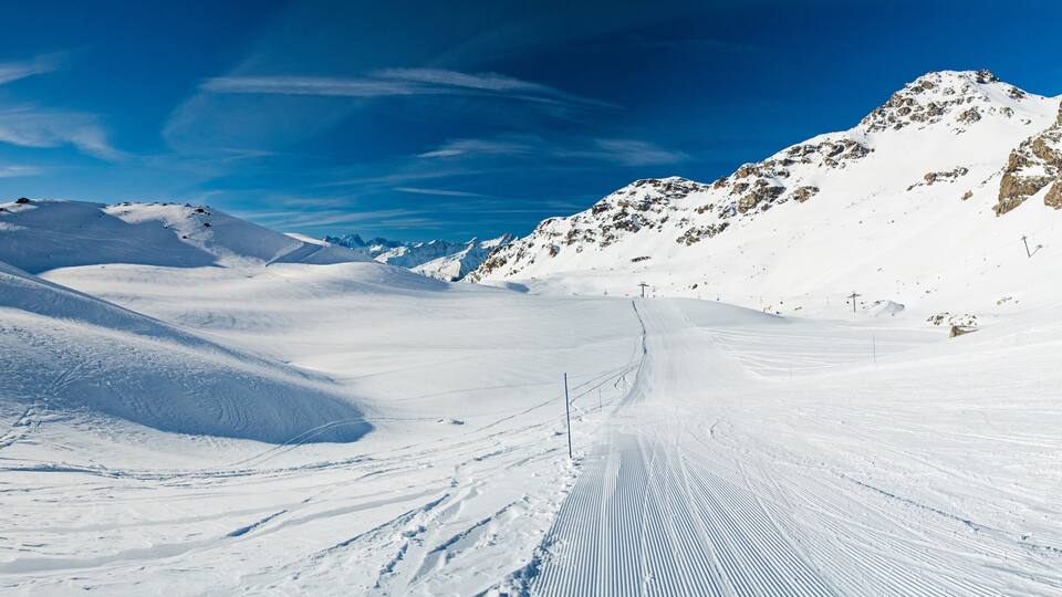Skiers on a piste in alpine ski resort