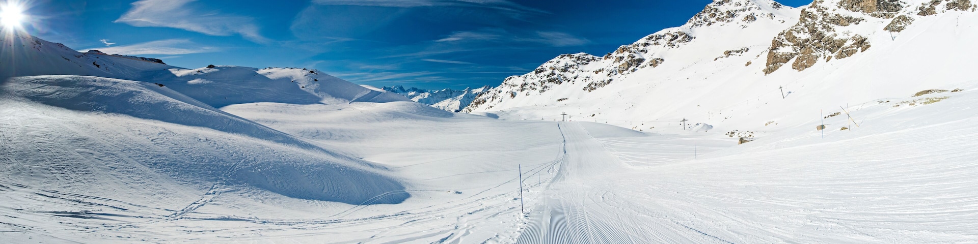Skiers on a piste in alpine ski resort