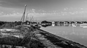 Several small sailboats tied up or beached at Barnegat Bay on Long Beach Island