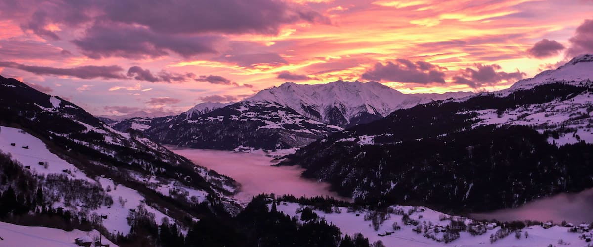 majestic and colorful sunset over a winter mountain landscape in the Alps