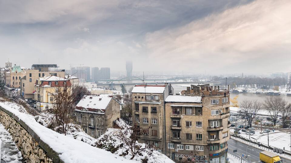 Winter panorama of Belgrade Kalemegdan fortress and park Sava river confluence and New Belgrade by day with snow