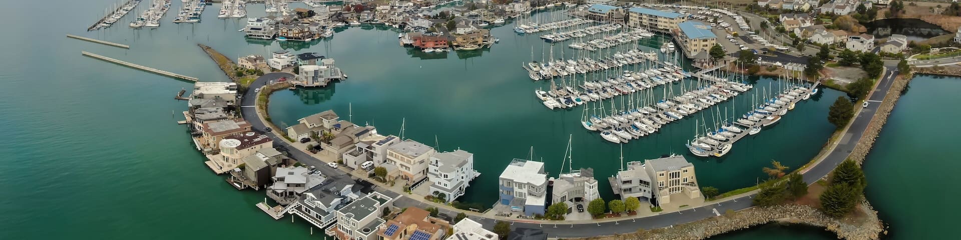 An aerial view shows houseboats and yachts docked in a marina in Richmond, California, USA. The unique waterfront community offers a tranquil lifestyle.
