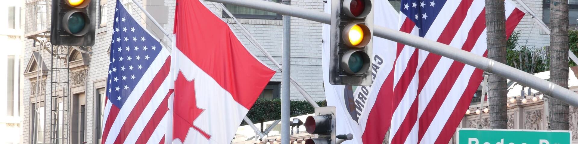 World famous Rodeo Drive Street Road Sign in Beverly Hills against American Unated States flag. Los Angeles, California, USA. Rich wealthy life consumerism, Luxury brands, high-class stores concept.