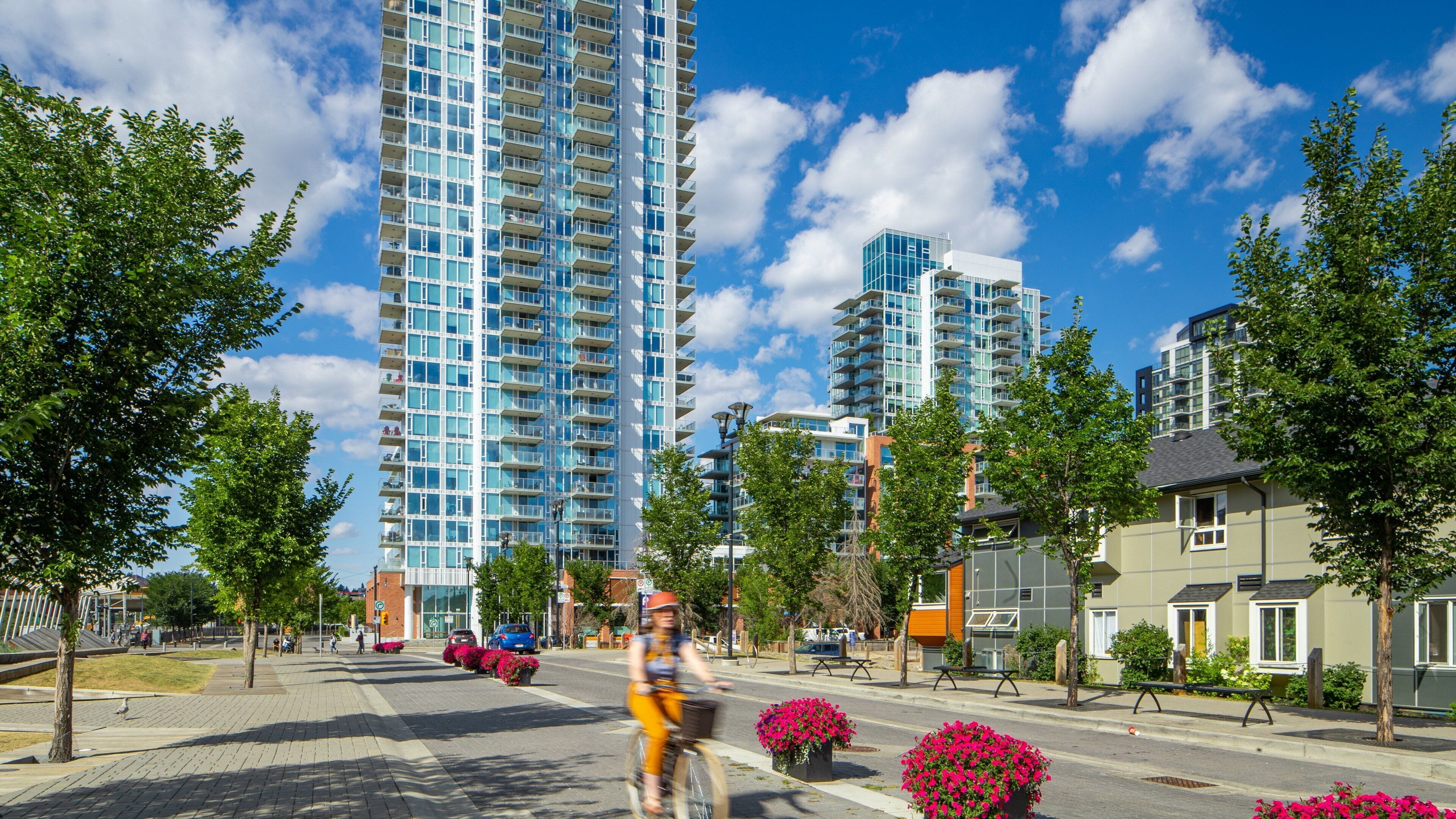 East Village showing a high rise building, street scenes and road cycling