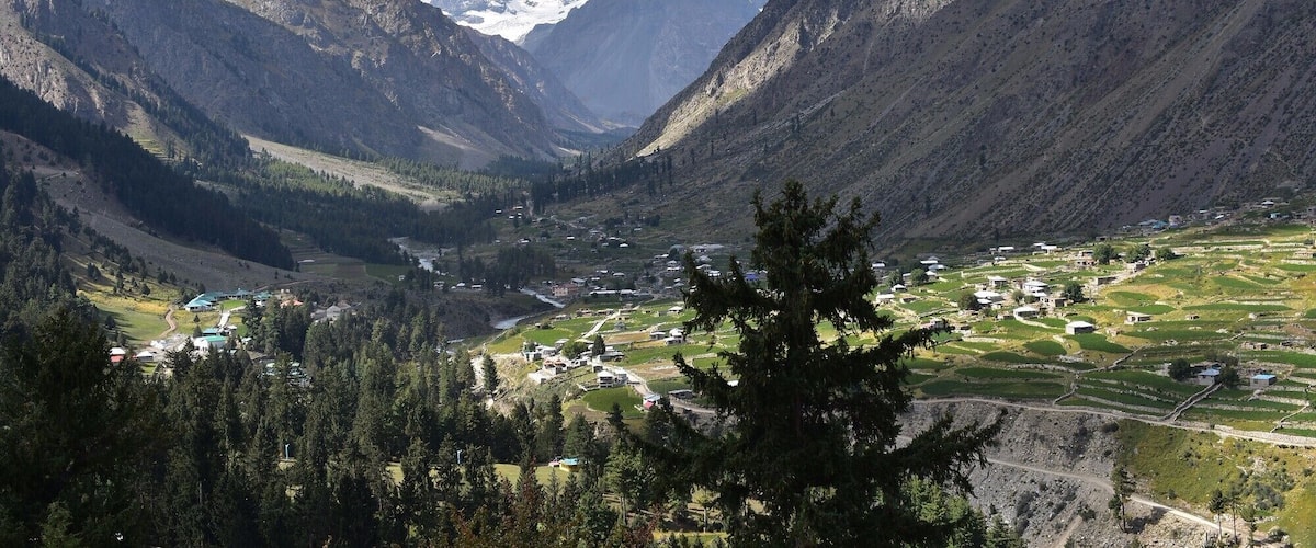 A mountainous valley with a small settlement nestled among the hills.