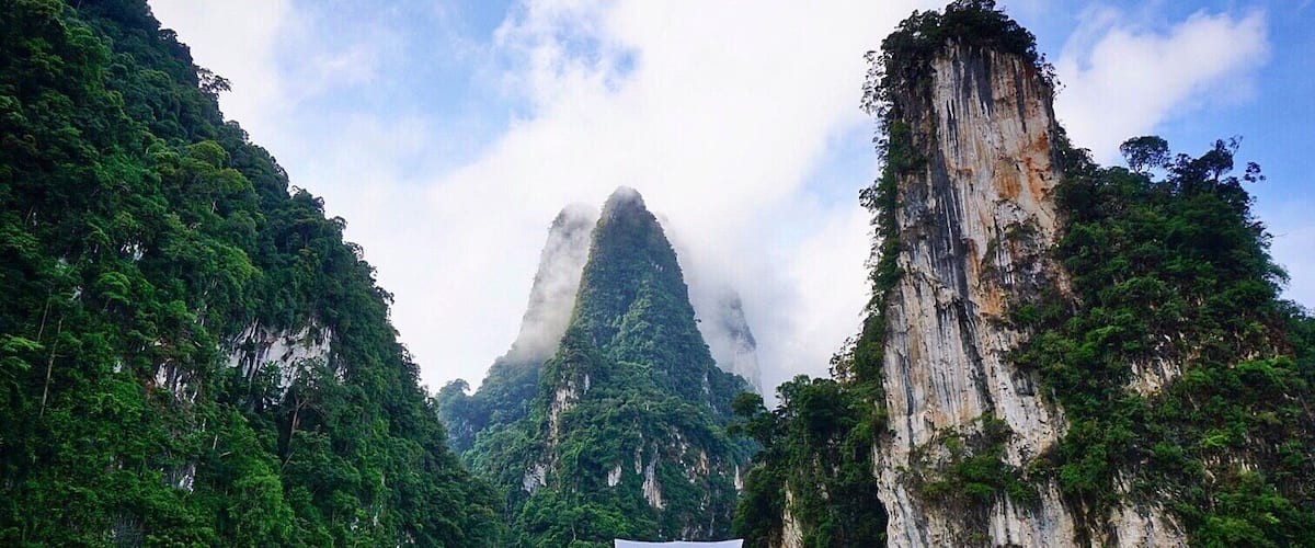 A boat on a river with a mountain in the background.