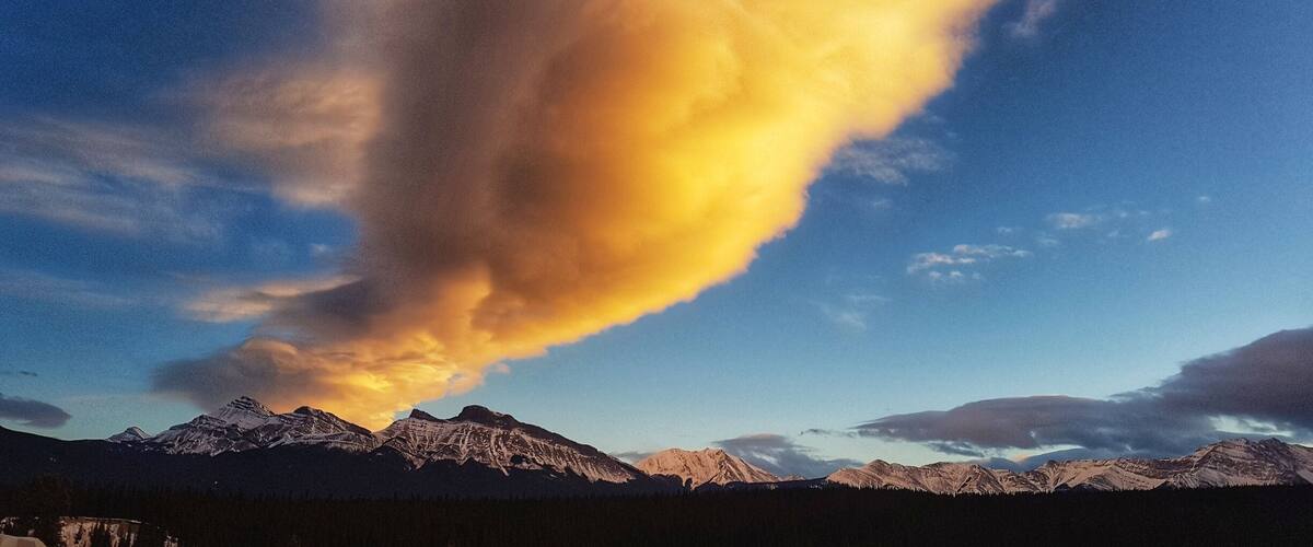 A mountain range with a prominent cloud formation.