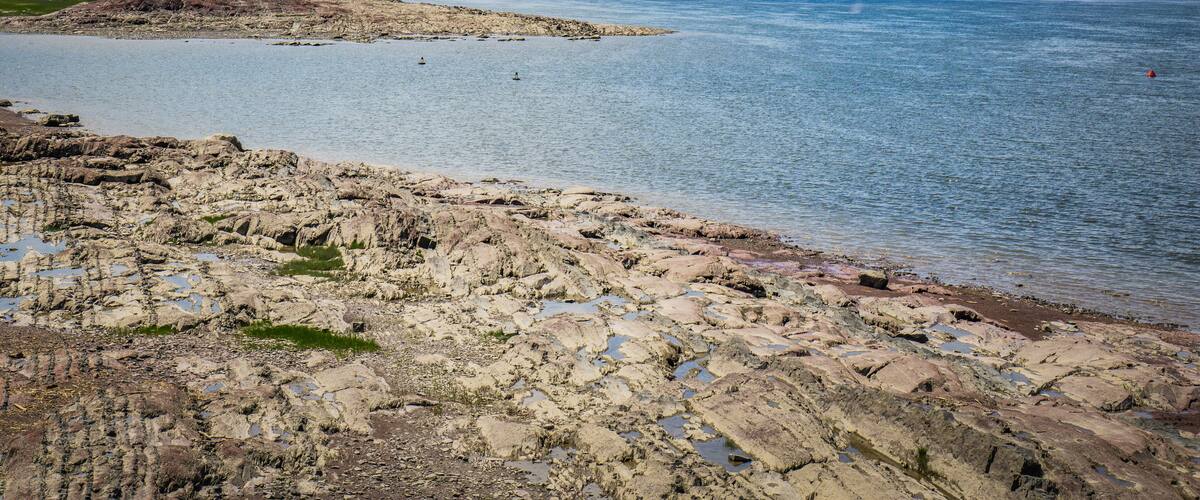 The rocky beach of the St Lawrence river in Berthier Sur Mer, a small town in the province of Quebec (Canada)