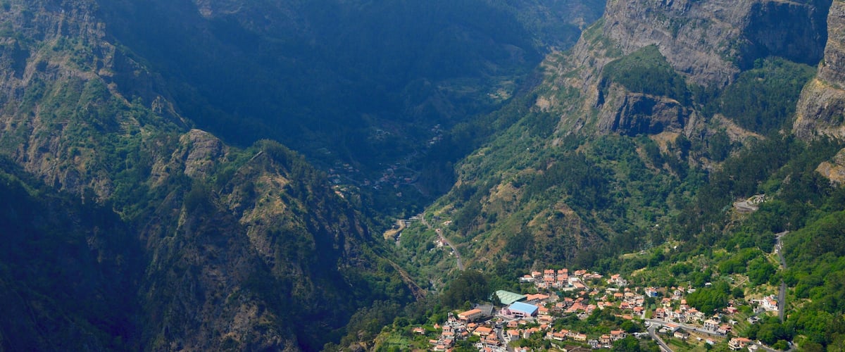 A mountainous landscape with a village nestled in a valley.