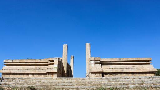 A Beautiful Stone architecture of a temple exterior against the blue sky in Karnataka, a perfect destinations for the travelers visiting India.