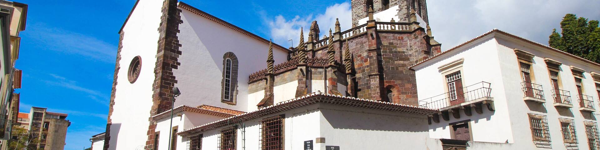 A historic church with a prominent bell tower and a white facade.