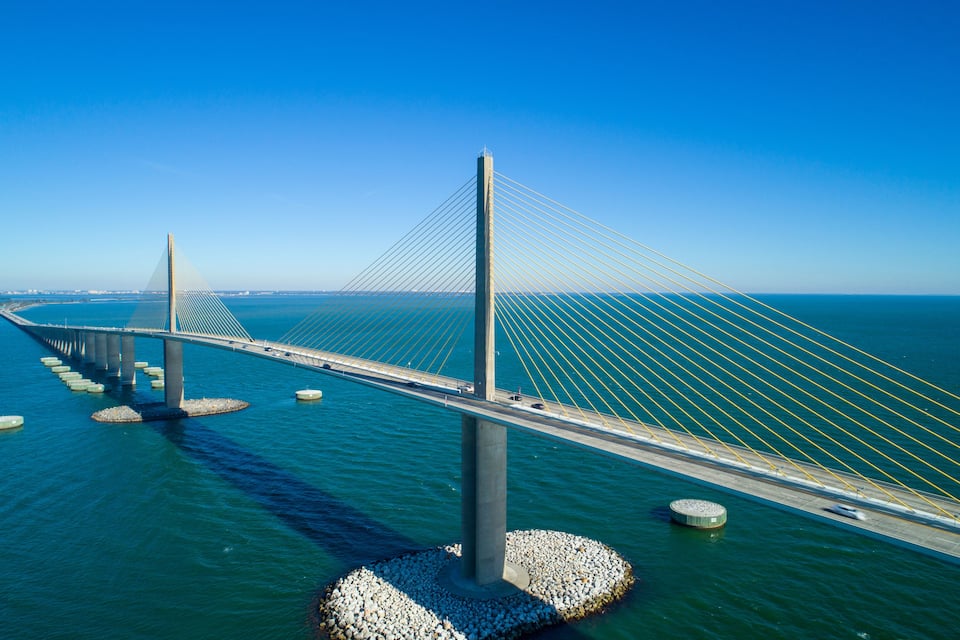 A cable-stayed bridge over water with multiple towers and cables.