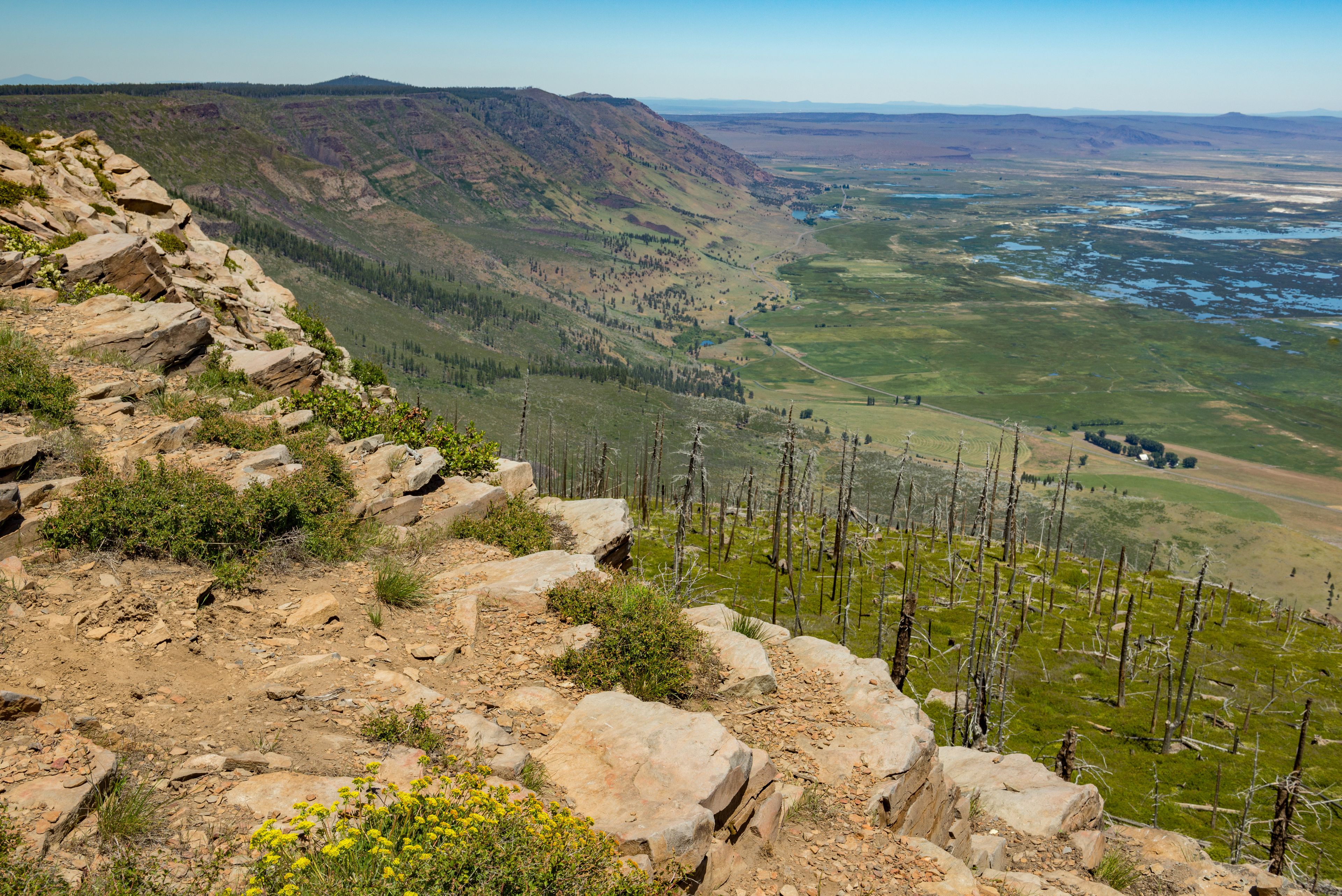 A mountainous landscape with rocky terrain and a river valley.