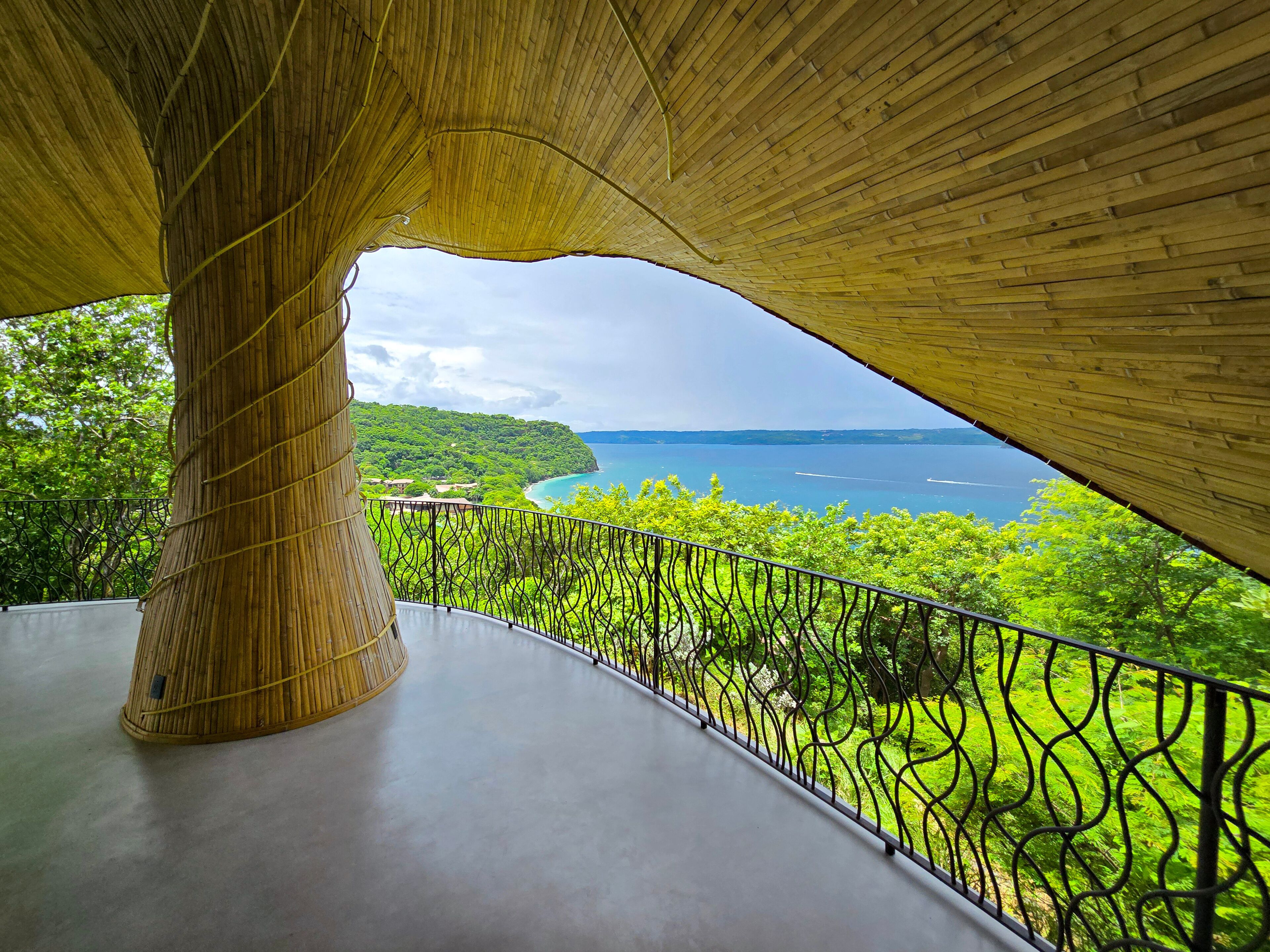 Estructura de bambú con vistas a un paisaje costero.