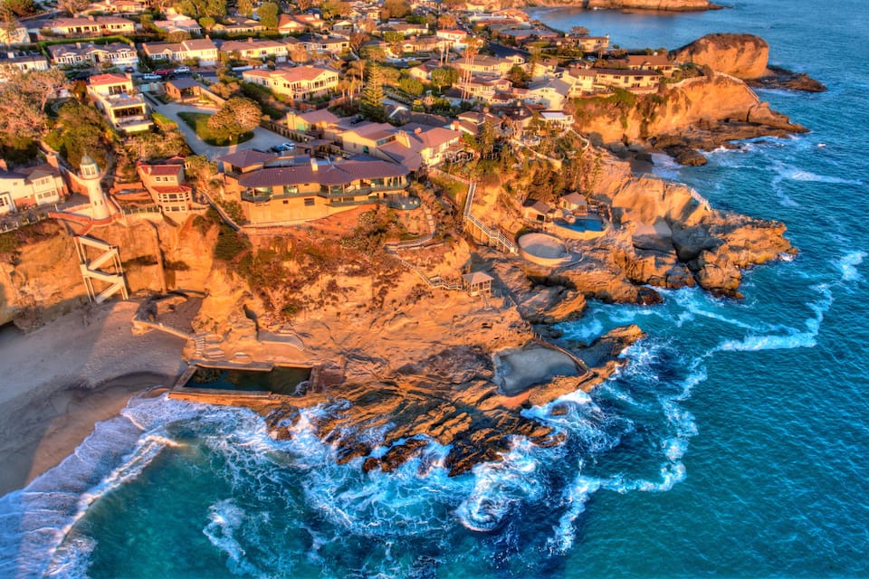 A coastal town with houses on cliffs overlooking the ocean.