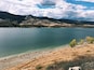 A lake surrounded by mountains and a rocky shoreline.