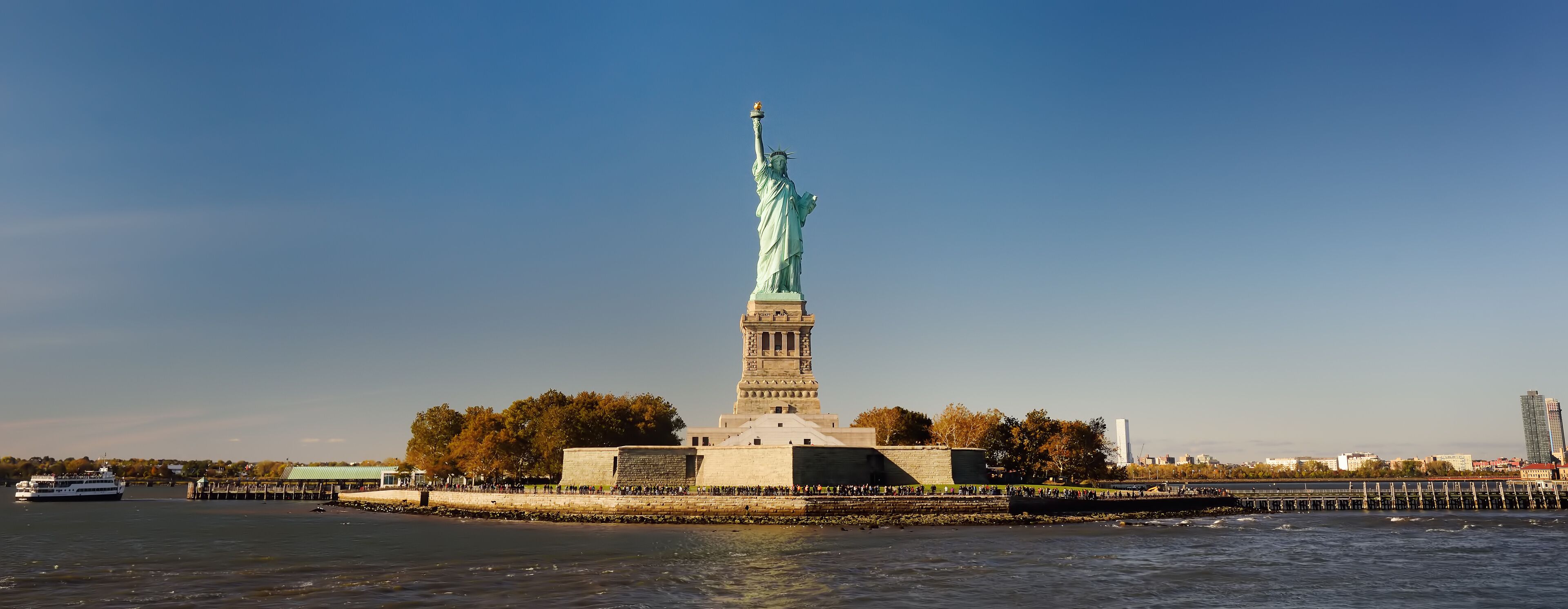 Panorama of island of Liberty with statue of Liberty seen from the ferry in the Hudson river.