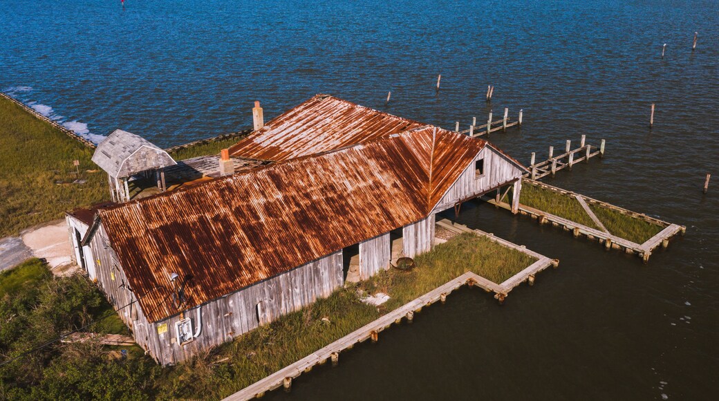This is an aerial of an abandoned oyster house along the shores of Chincoteague Bay on George Island Landing, a declined oyster, clam, and crab fishing village in Maryland.