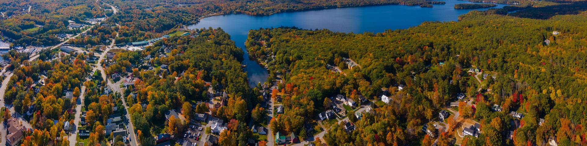 Panoramic aerial view of Lake Waukewan in fall from town center of Meredith, New Hampshire NH, USA.