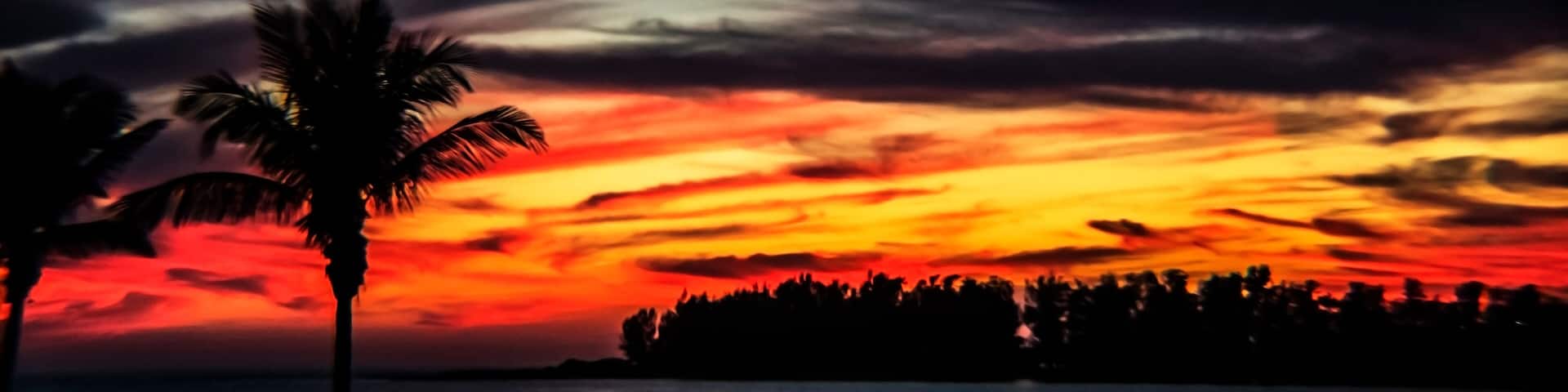 sunset over the bay, water, sky, red, intense, swirls, clouds, landscape, island, horizon, tropical, Siesta Key, Florida