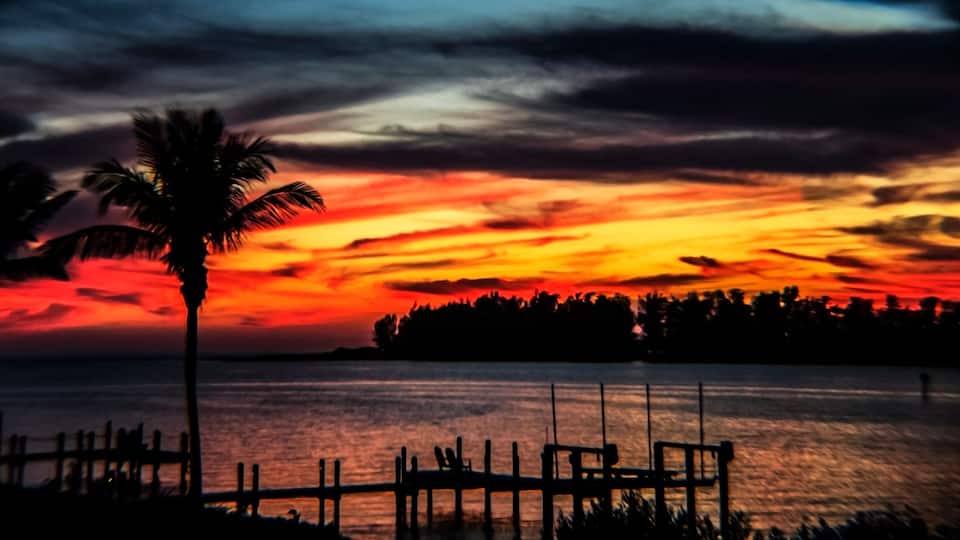sunset over the bay, water, sky, red, intense, swirls, clouds, landscape, island, horizon, tropical, Siesta Key, Florida