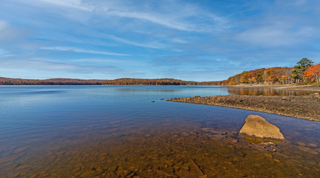 Lake Wallenpaupack in Poconos PA on a bright fall day lined with trees in vivid and beautiful foliage
