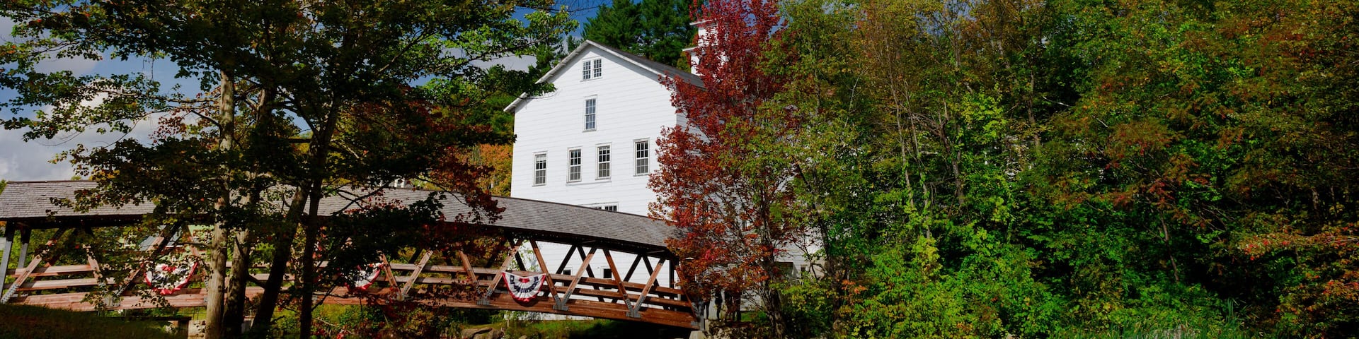Sunapee harbor covered bridge and typical New England house and tree