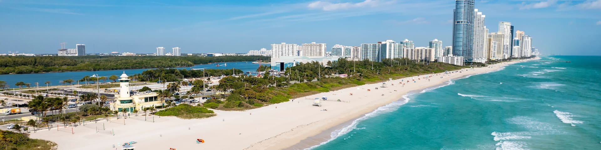Haulover Beach, Florida - Aerial view of Haulover Park with turquoise Atlantic waters, lifeguard tower, and Sunny Isles skyline along the beachfront