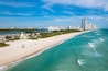 Haulover Beach, Florida - Aerial view of Haulover Park with turquoise Atlantic waters, lifeguard tower, and Sunny Isles skyline along the beachfront
