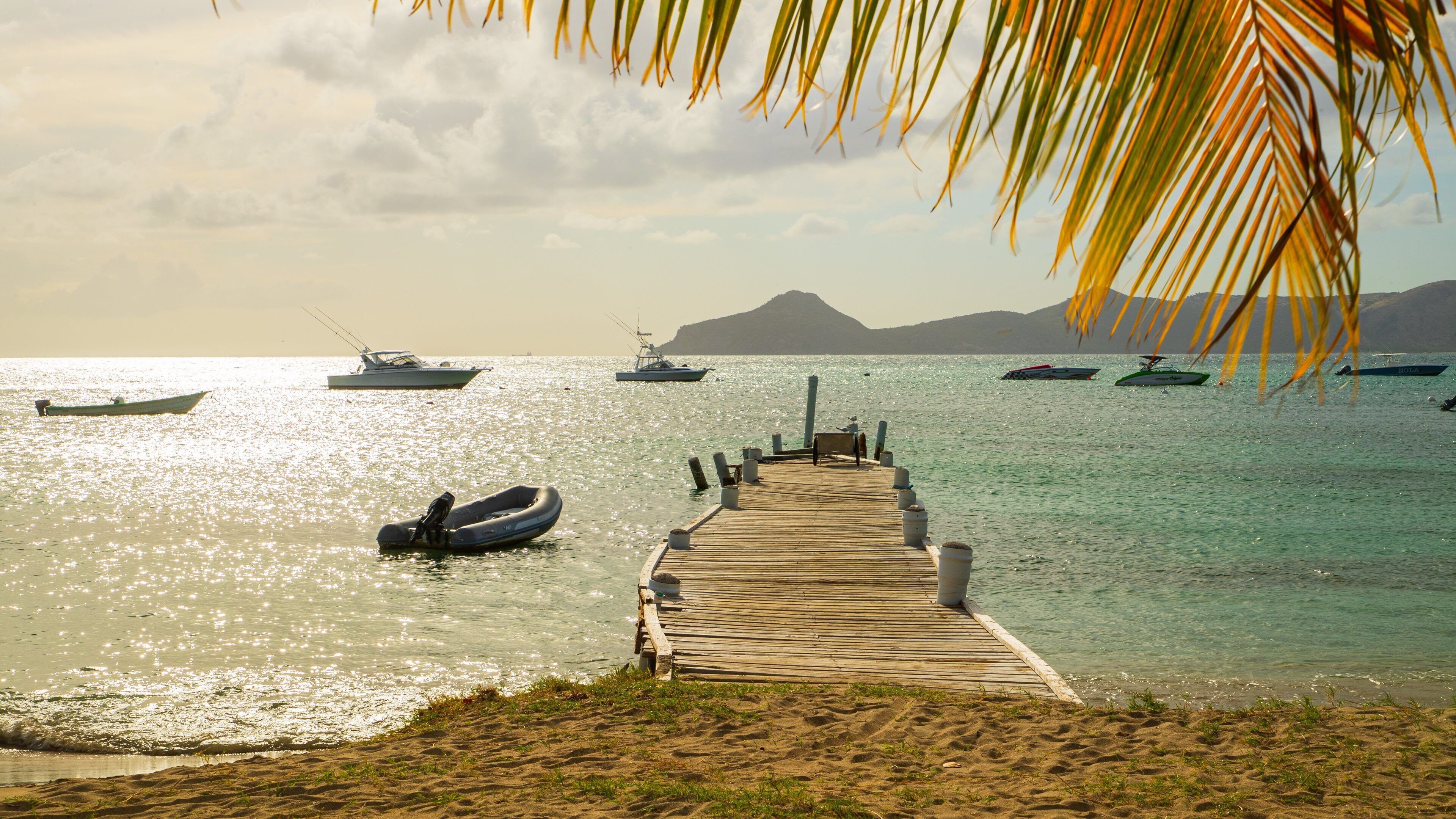 Oualie Beach showing a sunset, general coastal views and a bay or harbor