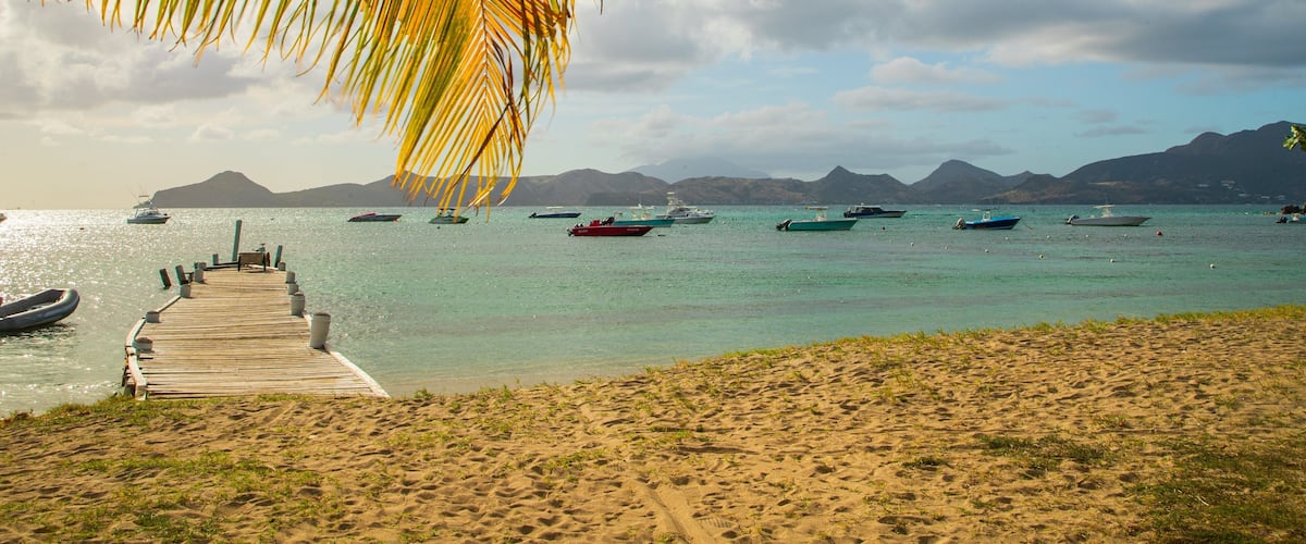 Oualie Beach which includes a sandy beach, tropical scenes and general coastal views