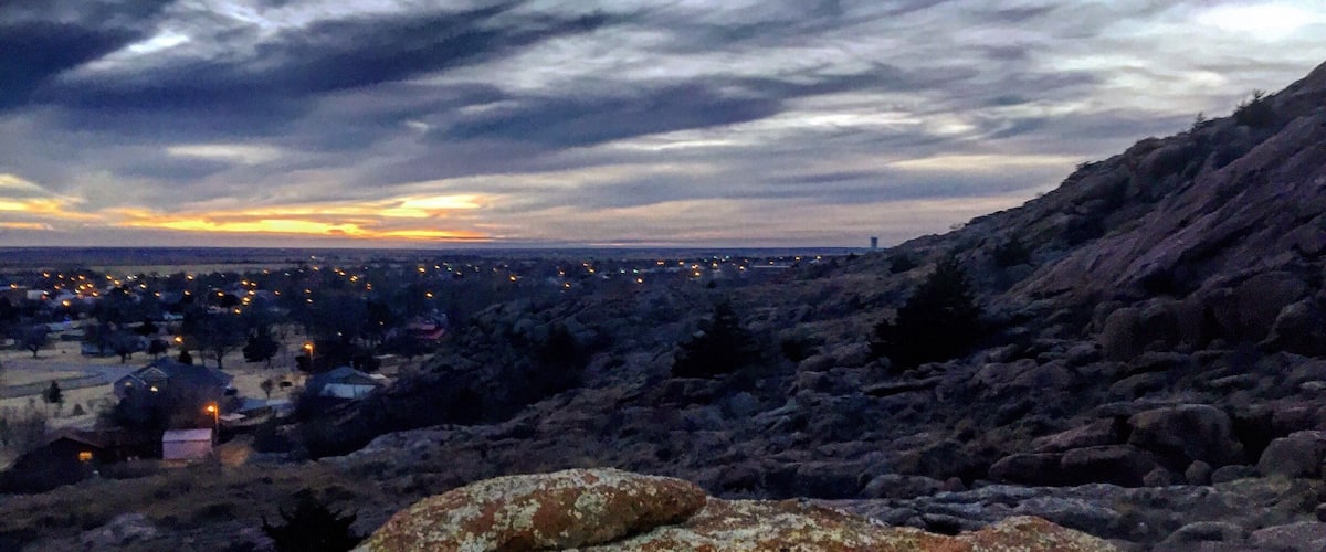 A rocky landscape with a sunset in the background.
