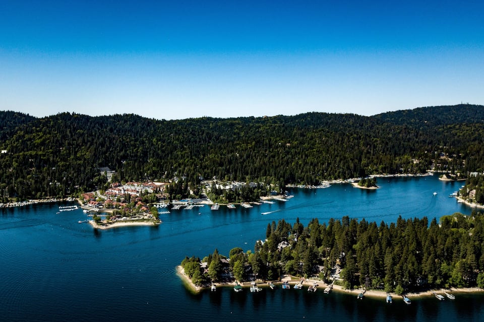 A lake surrounded by dense forests and small settlements.