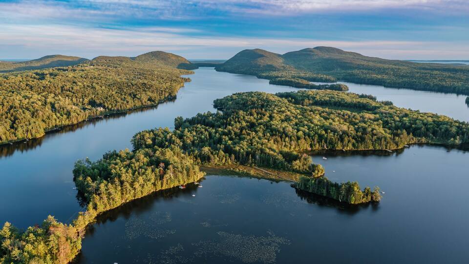 A lake surrounded by forested hills.