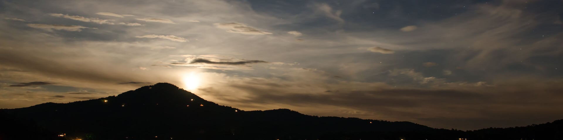 Moon rise with stars, clouds, and mountains at Lake Burton, Georgia.
