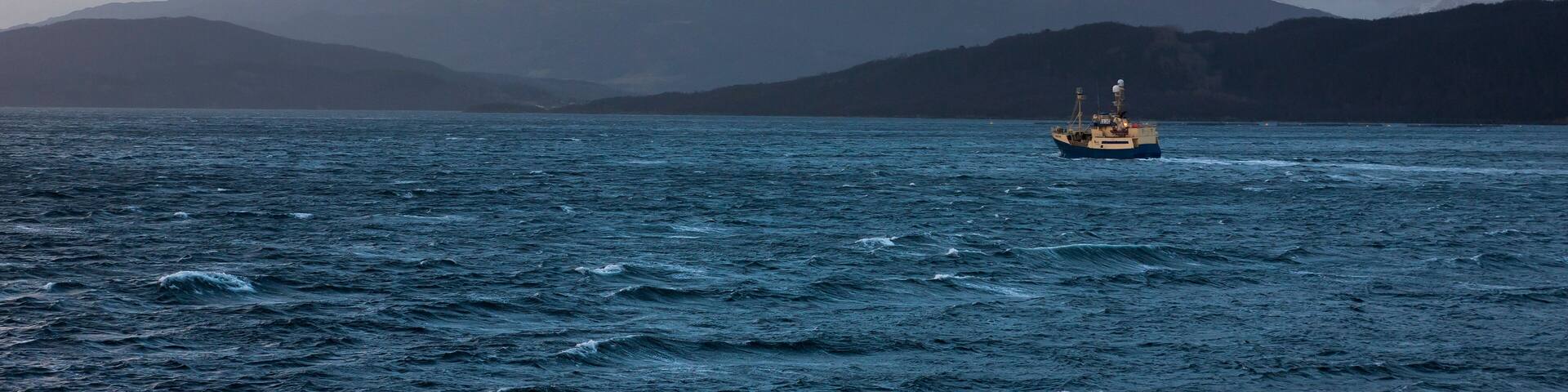 Fishing vessel heading home, running from an impending gale: Tranøyfjorden, Troms, Norway