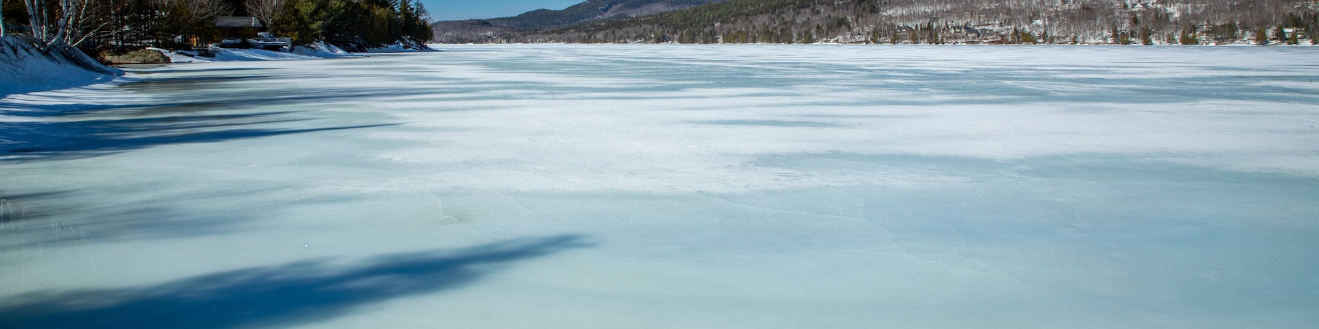 Lake Tremblant showing snow and a lake or waterhole